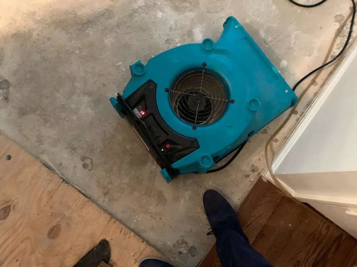 Air mover drying subfloor during Leak Detection & Repair in McLean